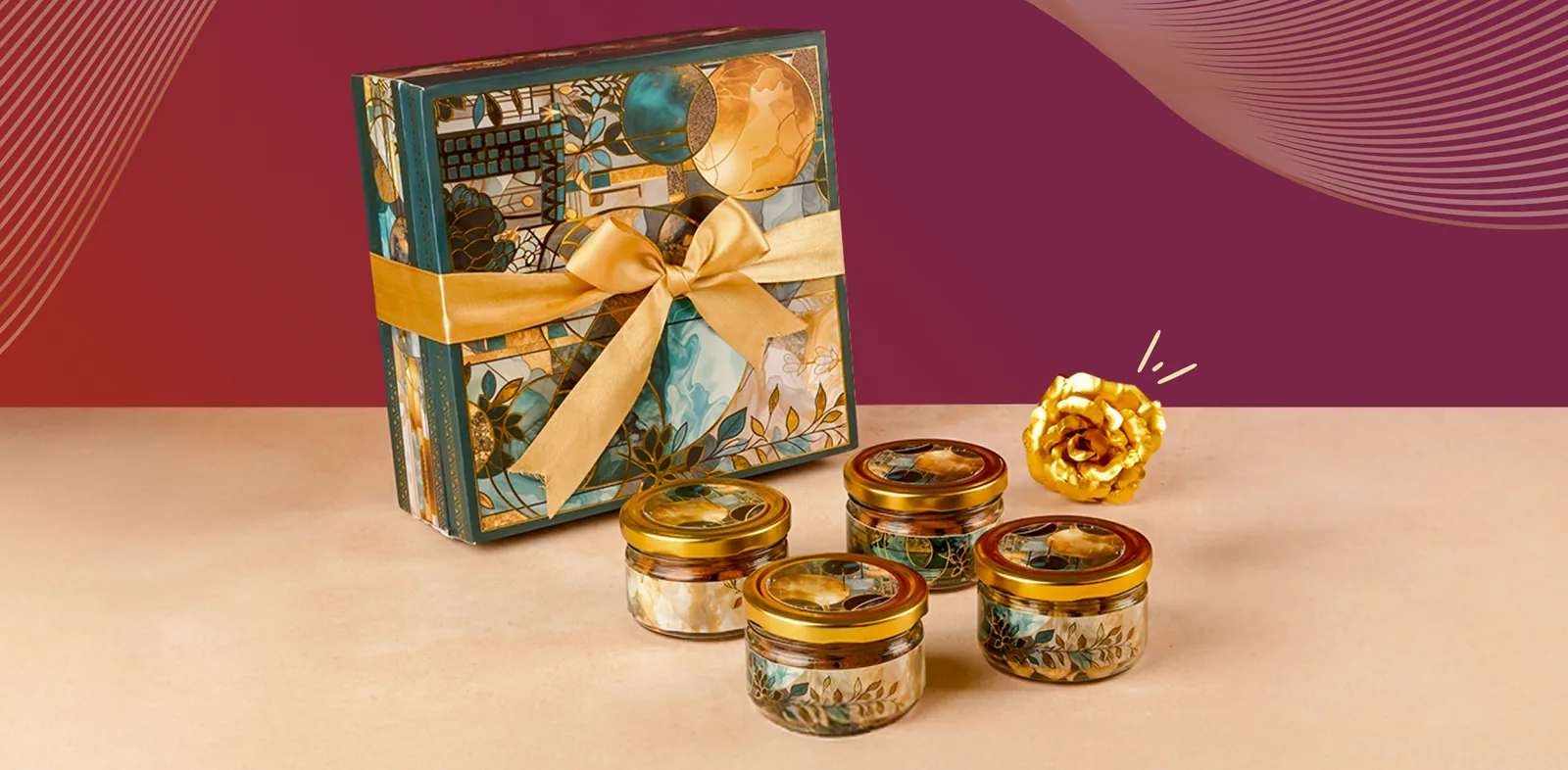 An Oorla gift box in a teal and gold print, tied with a gold ribbon, beside four glass jars in printed wraps and a golden rose, on a crimson ground