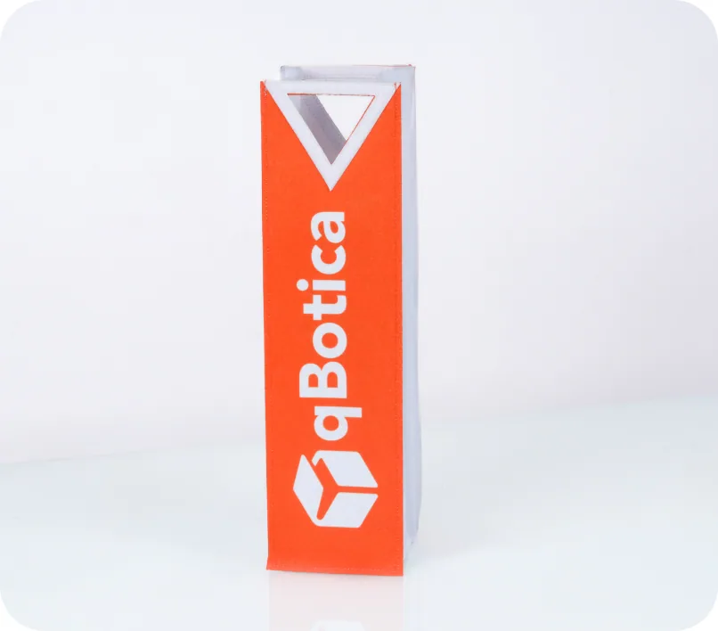 A tall orange bottle-carrier box printed edge to edge with the qBotica logo
